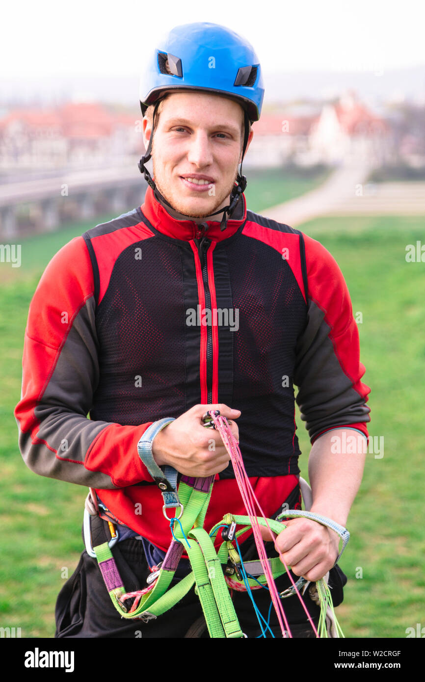 Young parachutist holding parachute slings and smiles Stock Photo Alamy