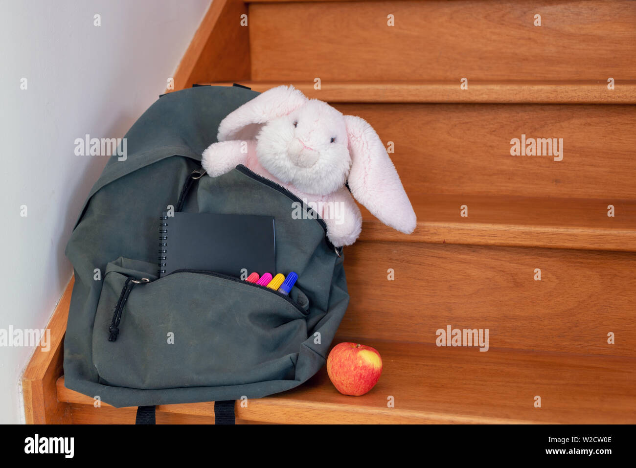 School bag with cuddly toy, supplies and lunch Stock Photo