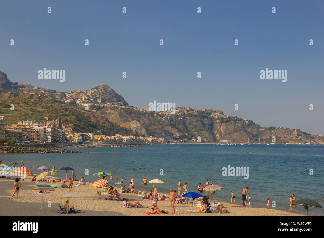 Giardini Naxos Sicily Italy 2019 scenic view of the coastline and beach with people enjoying the vacation time in Summer Stock Photo