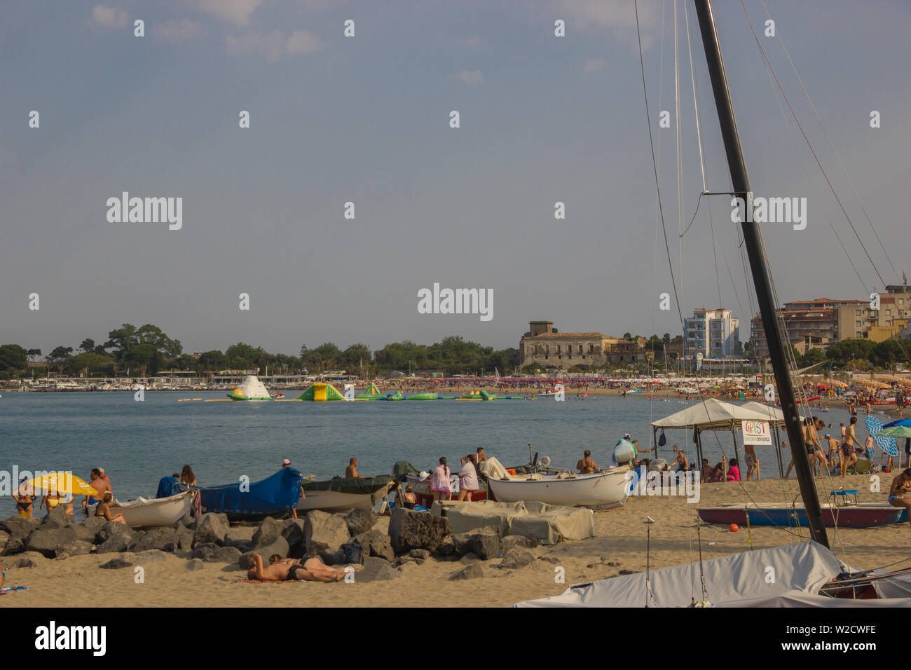 Giardini Naxos Sicily Italy 2019 view of the long beach with boats, tourist harbor and beautiful popular sea in Summer Stock Photo