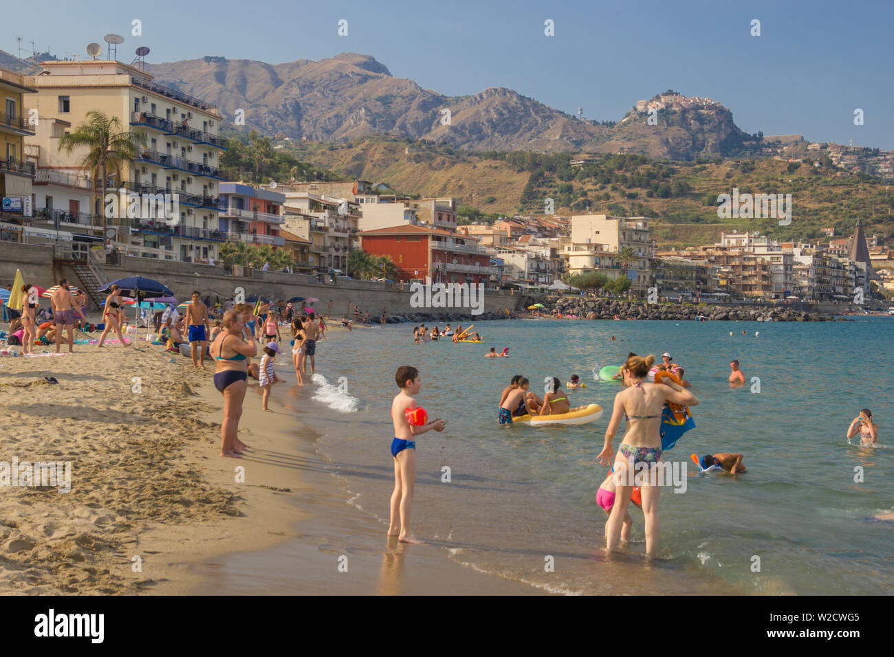 Giardini Naxos Sicily Italy 2019 Summer enjoyment at beach for people and tourists coming to this beautiful popular holiday location Stock Photo