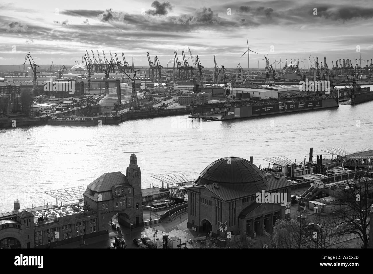 Hamburg , Germany - November 26, 2018: Hamburg port aerial view with port buildings and cranes on Elbe river coast. Retro stylized black and white pho Stock Photo