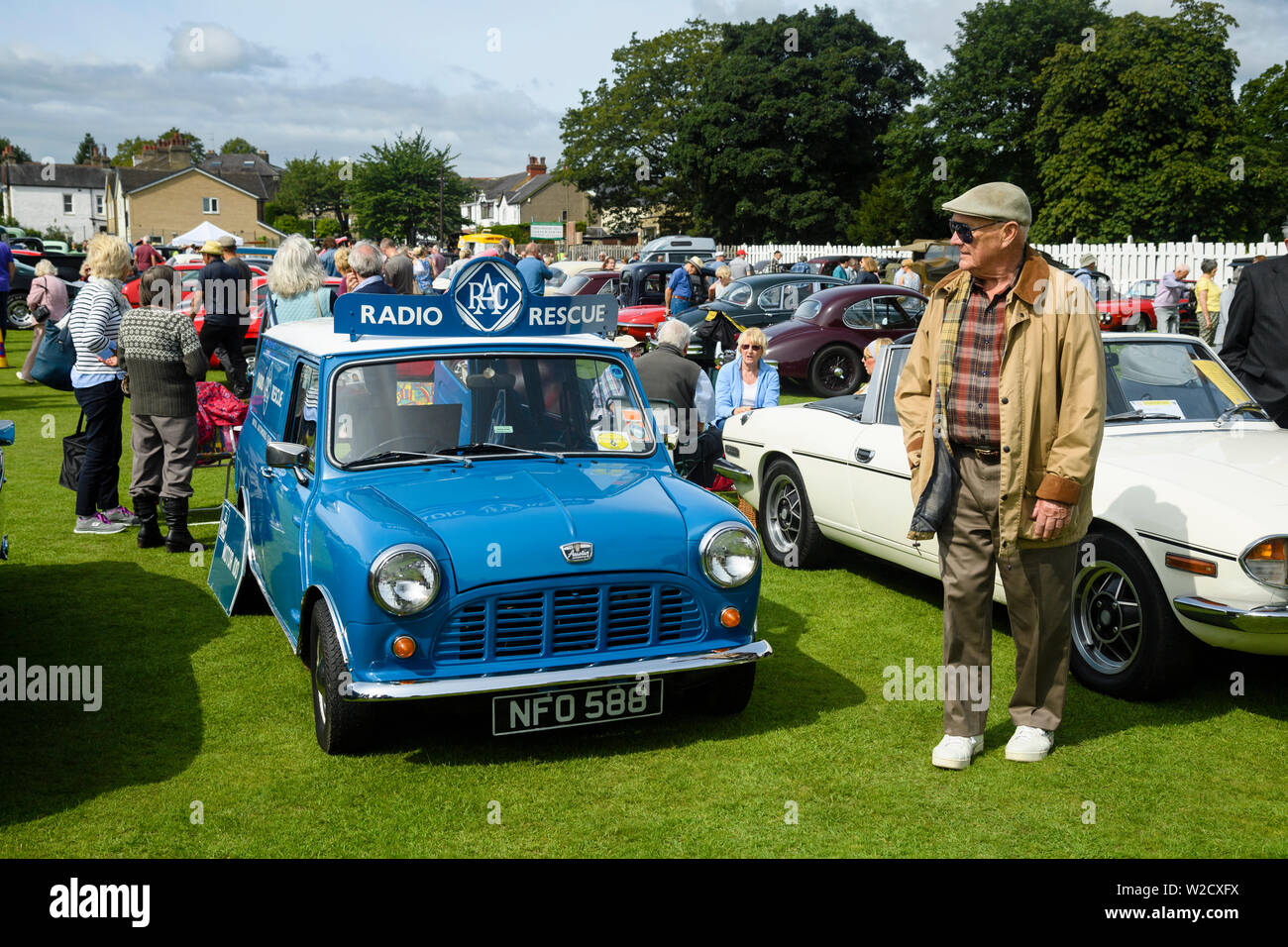 1961 commercial motorcar (Austin Mini Van RAC Radio Rescue) on display & people visiting Classic Vehicle Show - Burley-In-Wharfedale, England, UK. Stock Photo