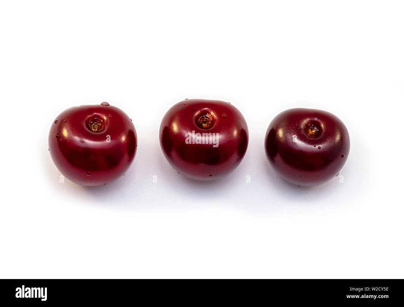 Three red Cherries isolated on white Background Stock Photo