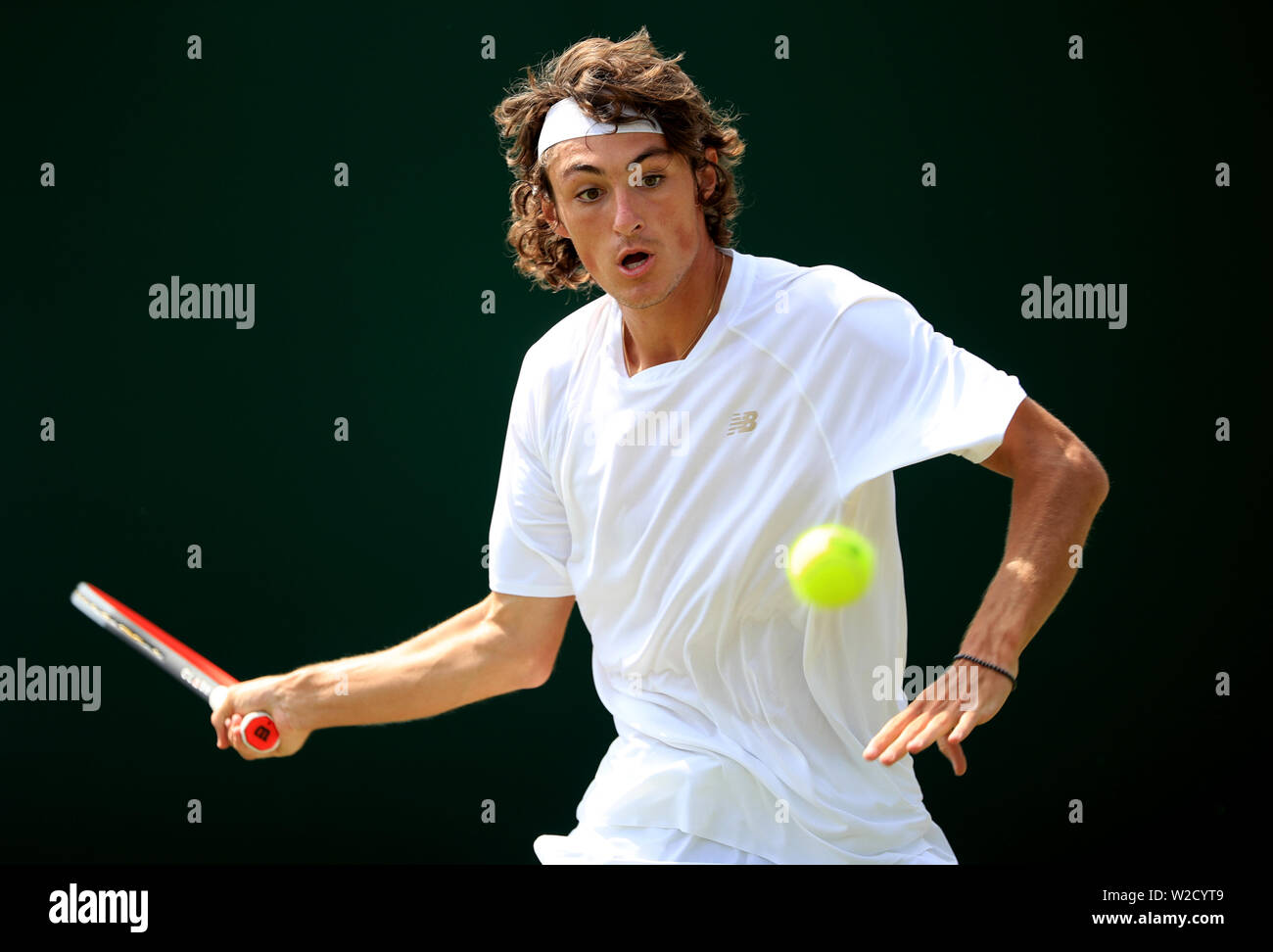 Baptiste Anelmo in action against Keisuke Saitoh during the boys singles on day seven of the Wimbledon Championships at the All England Lawn Tennis and Croquet Club, Wimbledon. Stock Photo