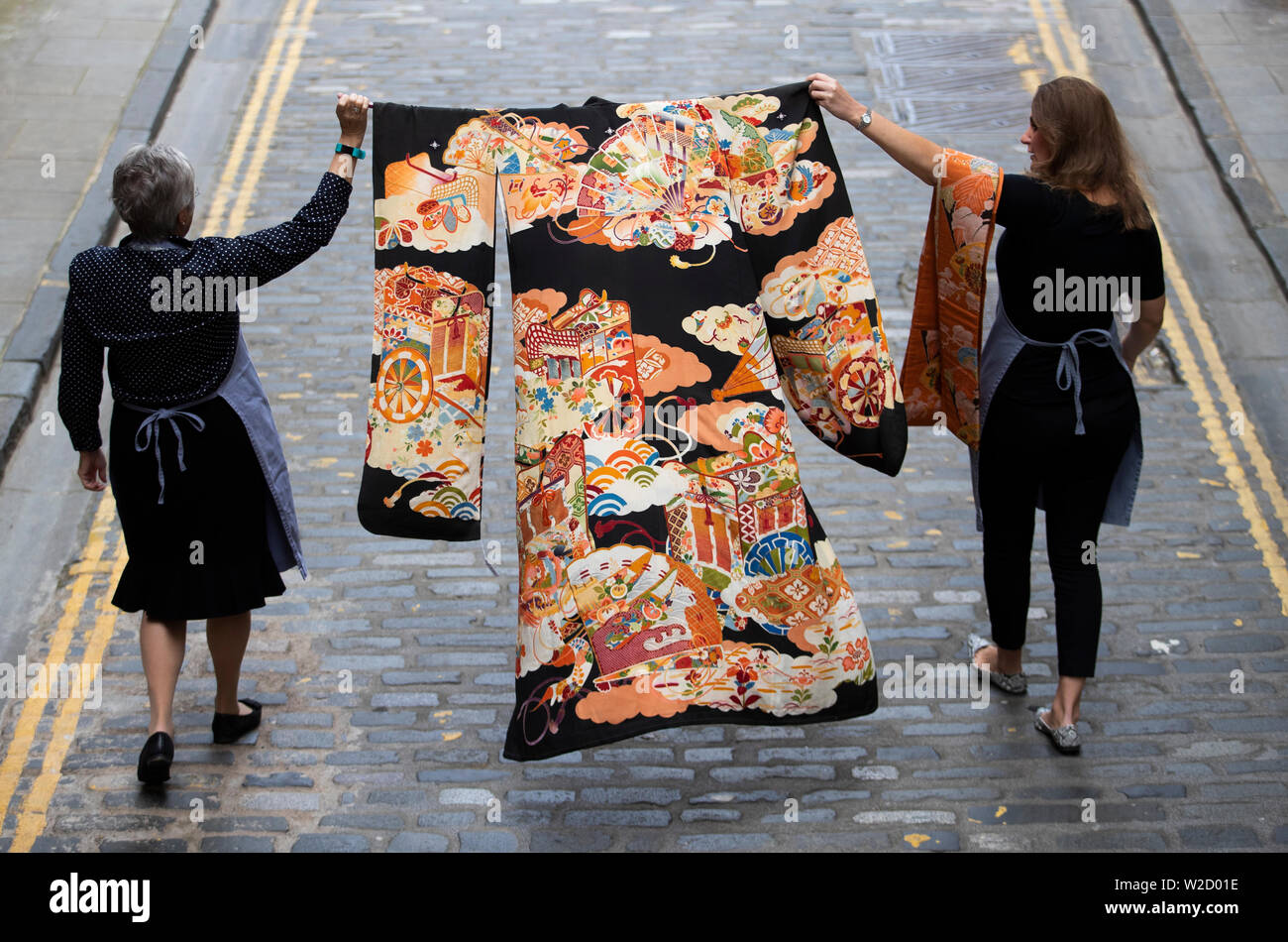 Lorna MacGregor (left) and Charlotte Canby, from Bonhams, Edinburgh, carry a rare 19th Century Japanese furisode silk kimono and obi (sash) which will be sold at auction in the forthcoming Asian Art Sale on Thursday July 11. Stock Photo