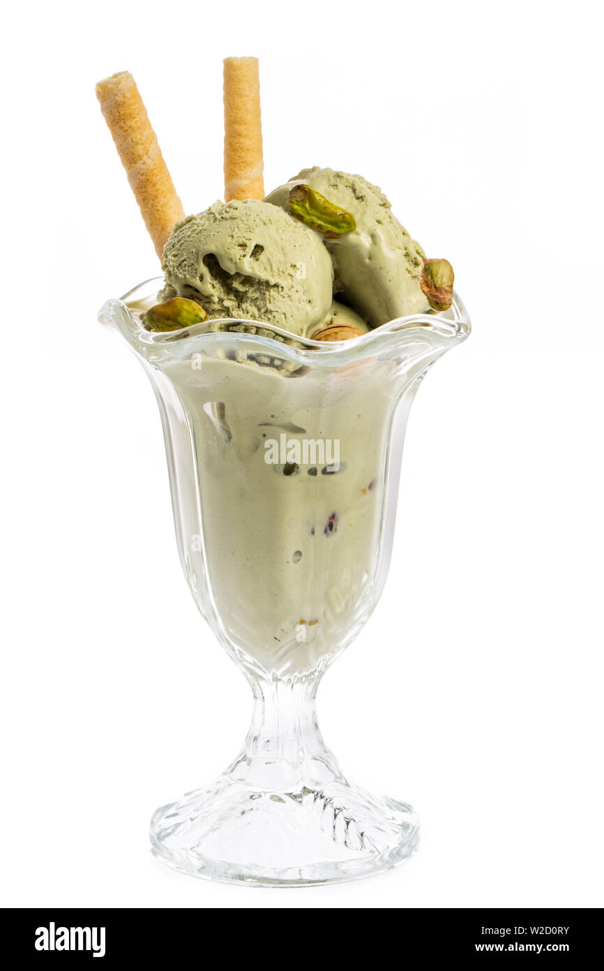 ice cream sundae: pistachio ice cream sundae with waffles and pistachio kernel isolated on white background - front view Stock Photo