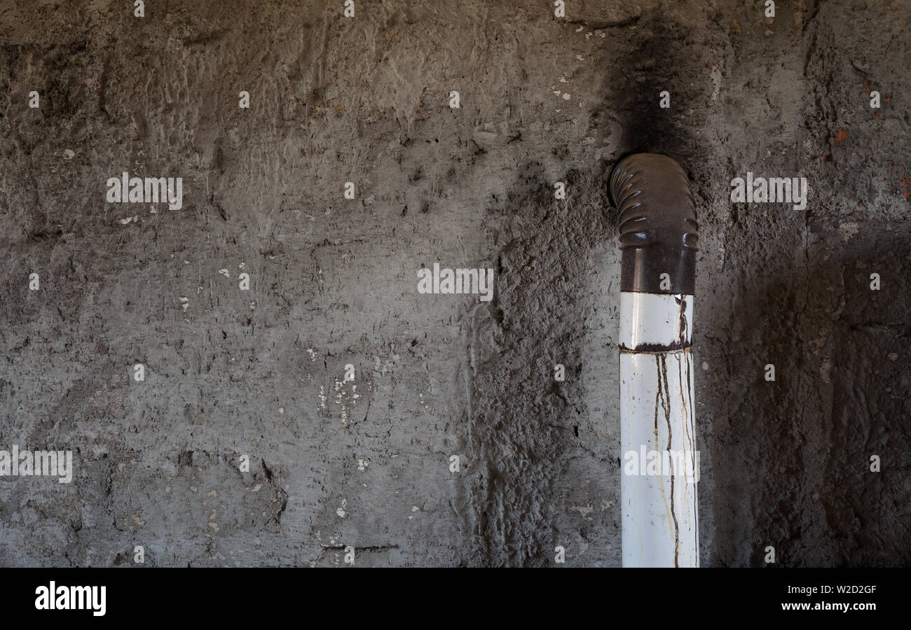 Texture of an old house wall and part of wood stove, abstract composition. Stock Photo