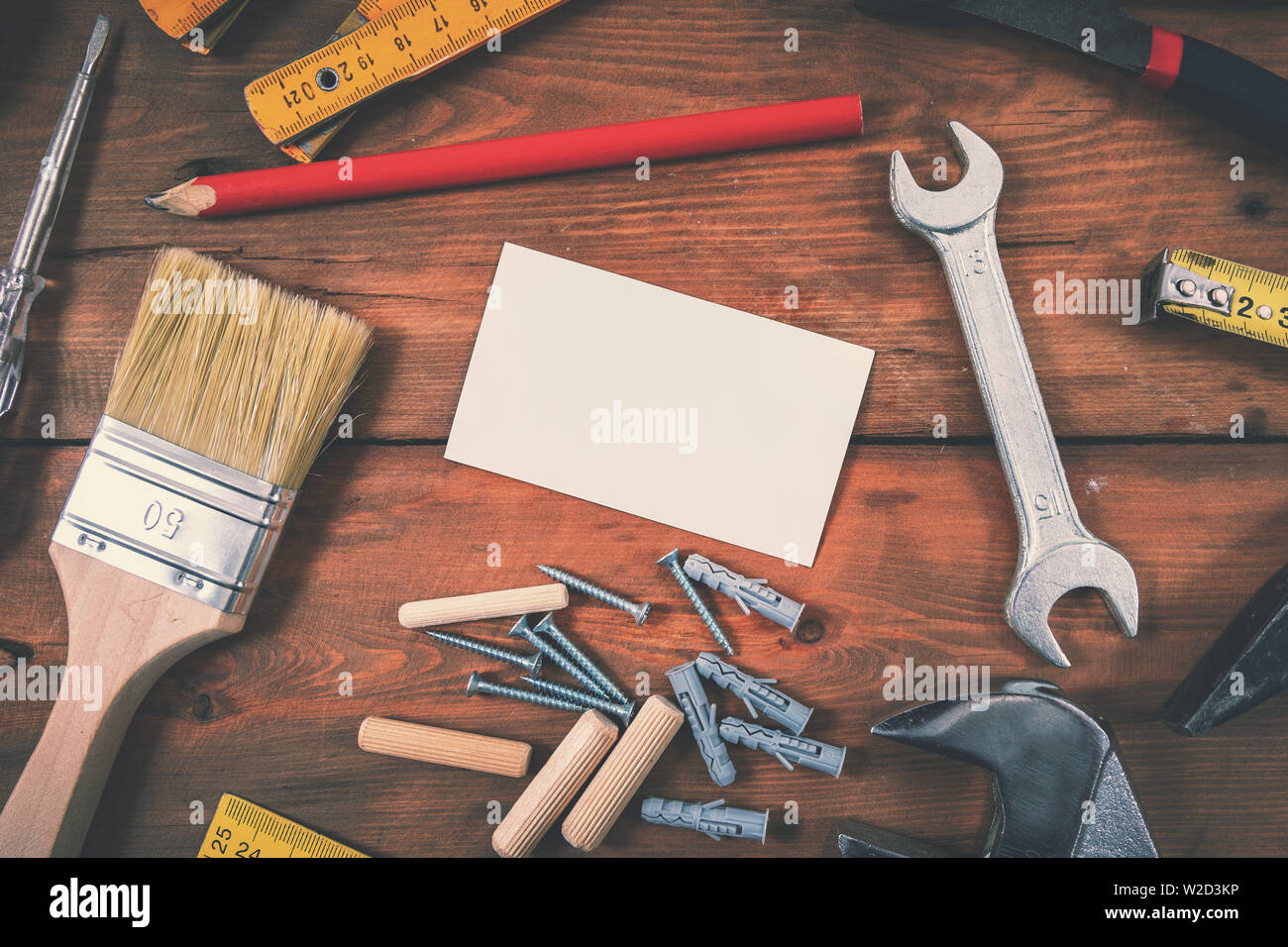 handyman services home repair - blank business card with construction tools on wooden background Stock Photo