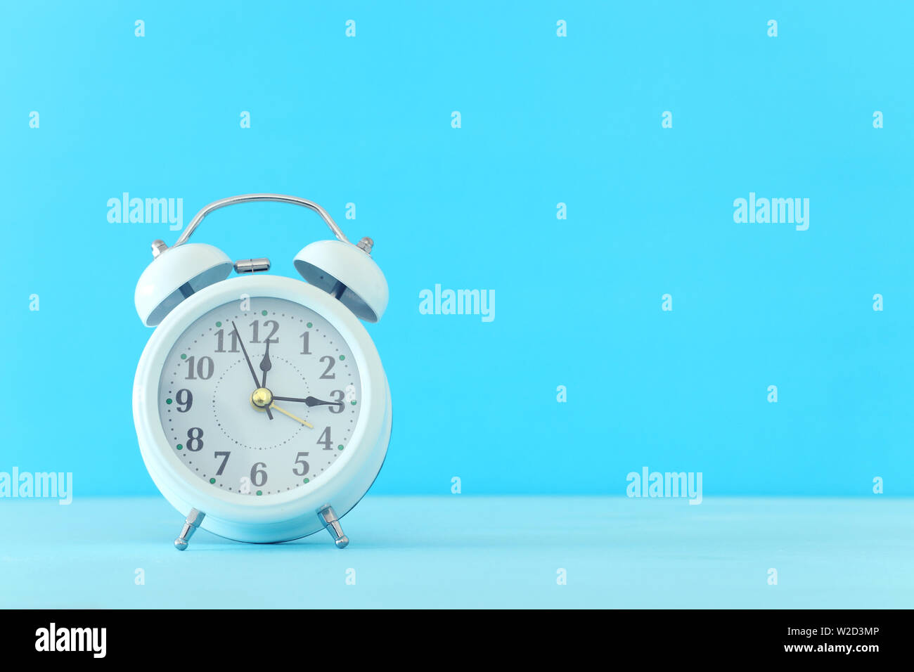 white retro clock over blue background Stock Photo Alamy