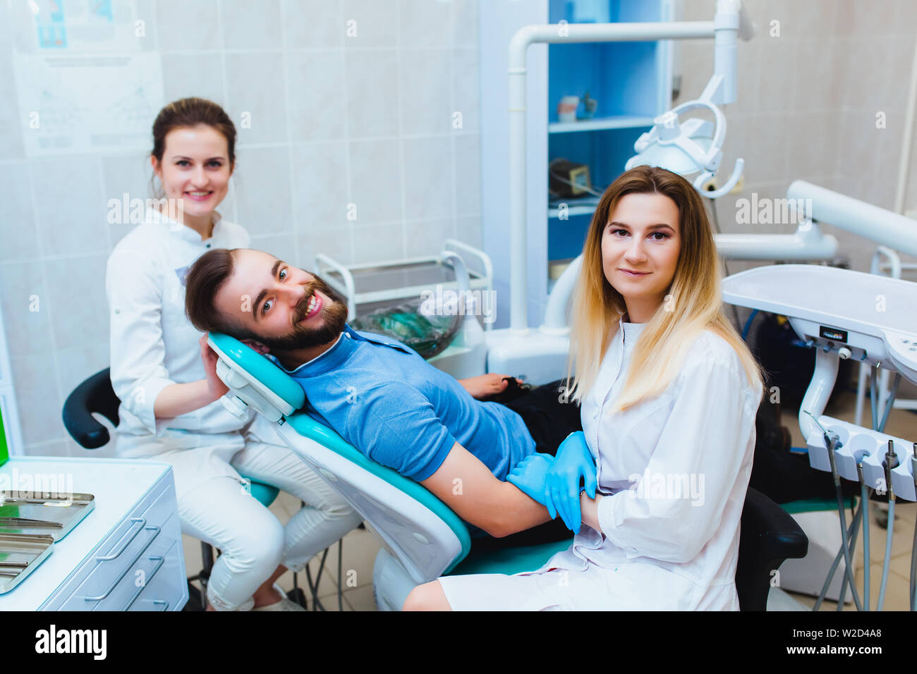 Dental clinic. Portrait of a professional dentist on the background of a working team of doctors