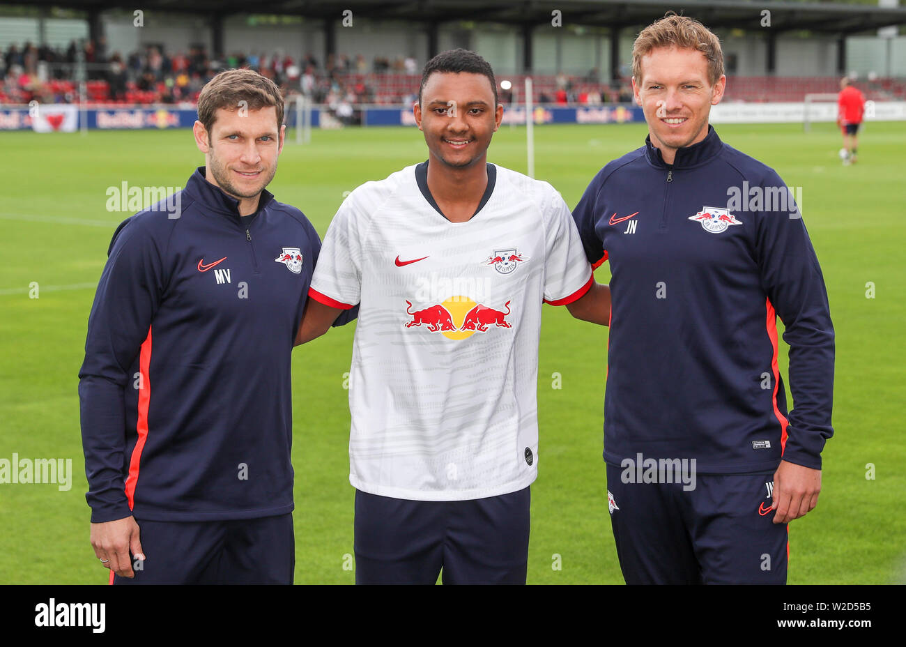 Leipzig, Germany. 08th July, 2019. Soccer: Bundesliga, RB Leipzig. The Leipzig newcomers: Co-trainer Moritz Volz (l-r), player Luan Candido and the new RB coach Julian Nagelsmann are on the court before the first training session. Credit: Jan Woitas/dpa-Zentralbild/dpa - IMPORTANT NOTE: In accordance with the requirements of the DFL Deutsche Fußball Liga or the DFB Deutscher Fußball-Bund, it is prohibited to use or have used photographs taken in the stadium and/or the match in the form of sequence images and/or video-like photo sequences./dpa/Alamy Live News Stock Photo