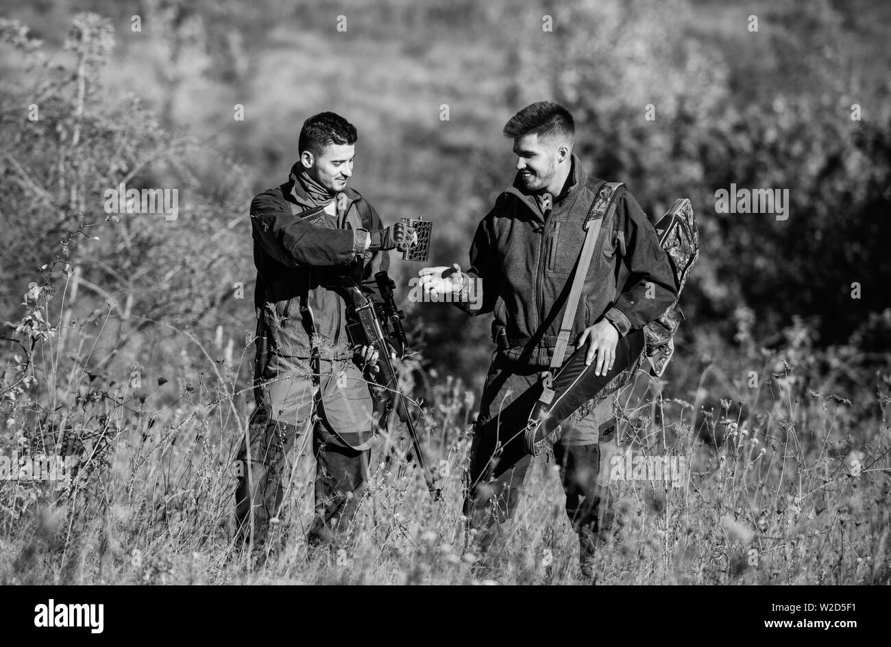 Army forces. Camouflage. Military uniform fashion. Friendship of men hunters. Hunting skills and weapon equipment. How turn hunting into hobby. Man hunters with rifle gun. Boot camp. Discussing catch. Stock Photo