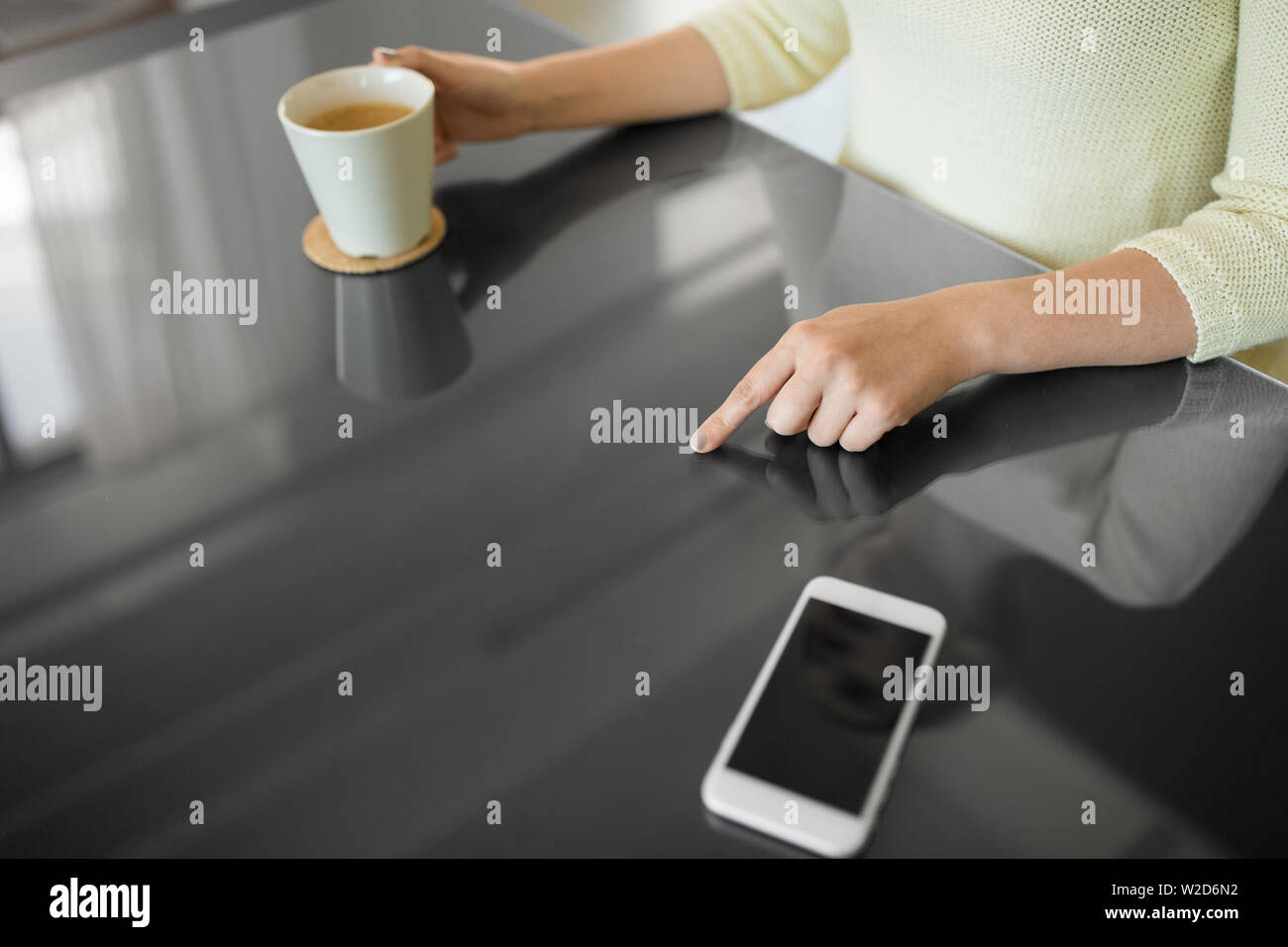 woman with coffee using black interactive panel Stock Photo