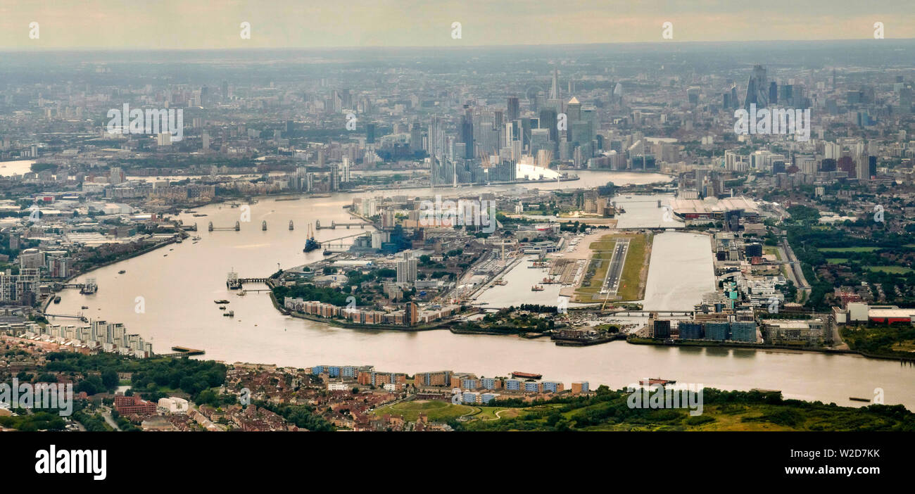 A High level view, Looking up the river Thames at the east end of London, with City Airport and Canary Wharf  and the Thames Barrier Stock Photo
