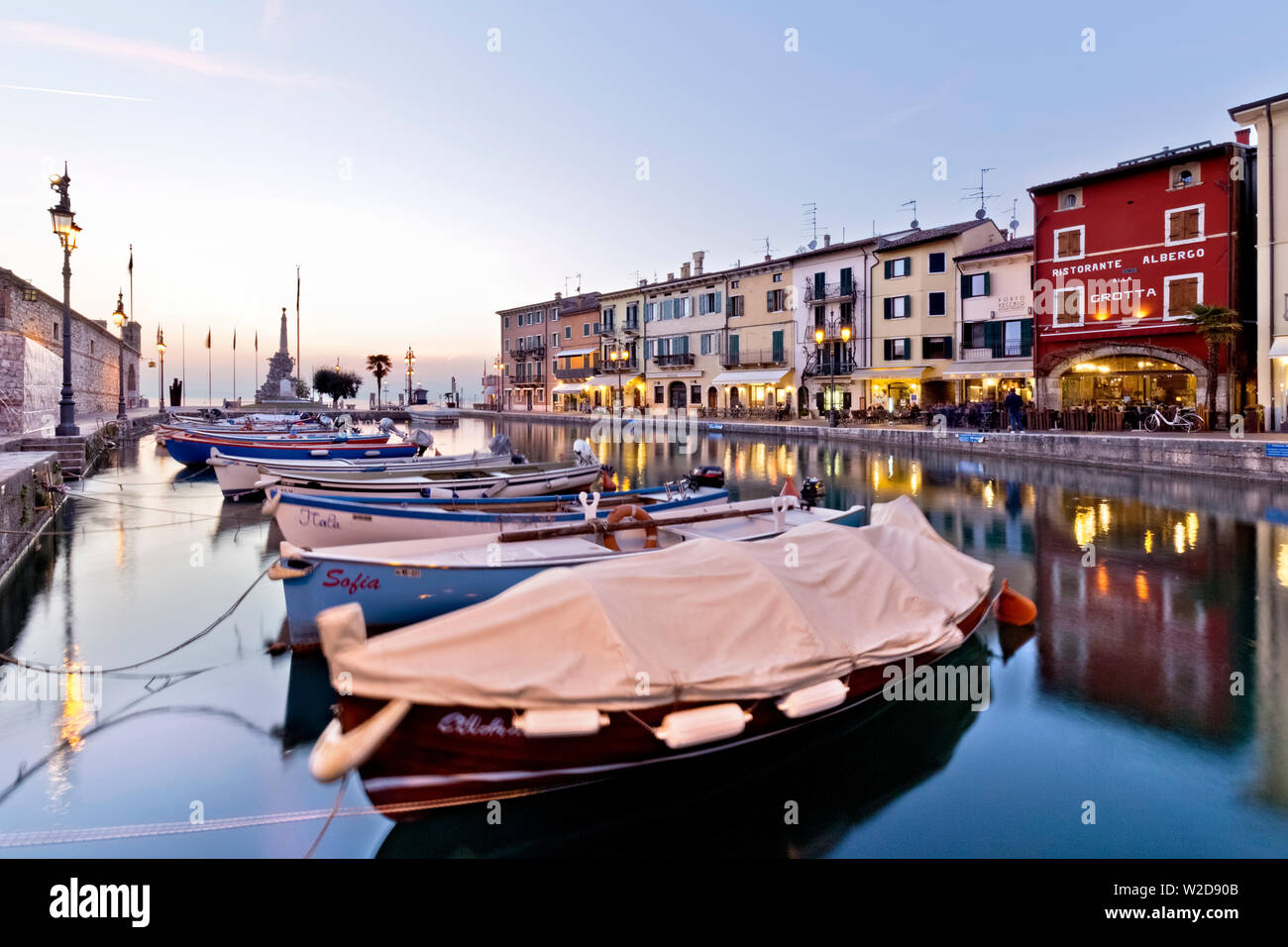 Boats moored at the ancient port of Lazise. Lake Garda, Verona province, Veneto, Italy, Europe. Stock Photo