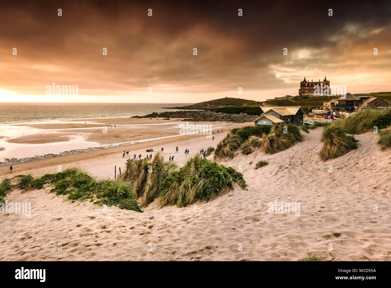 Golden light from the setting sun over Fistral in Newquay in Cornwall. Stock Photo