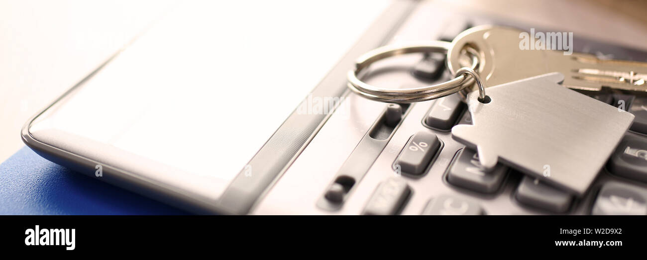 Calculator on Notepad, Key with Trinkel Desktop Stock Photo