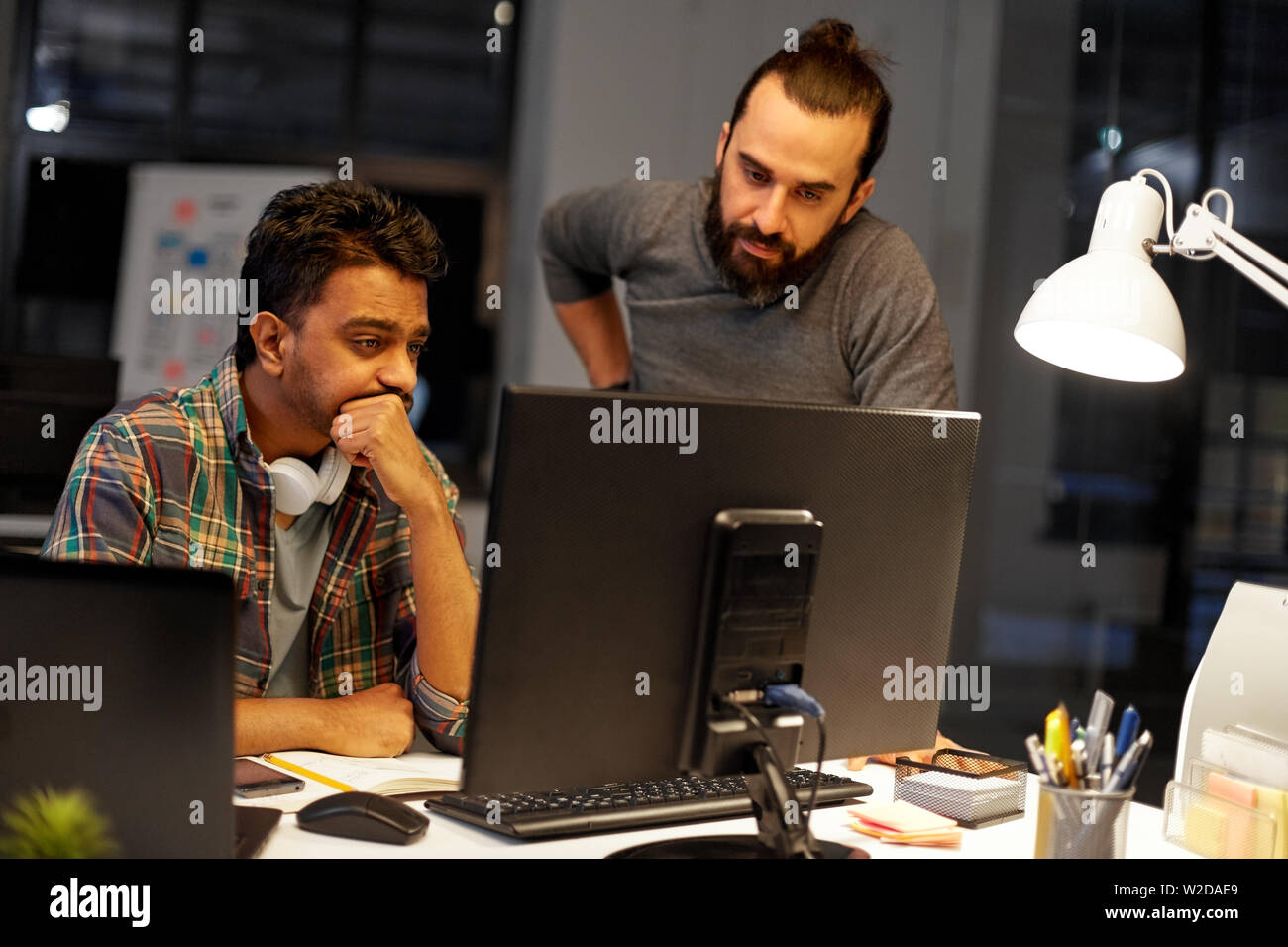 creative team with computer working late at office Stock Photo