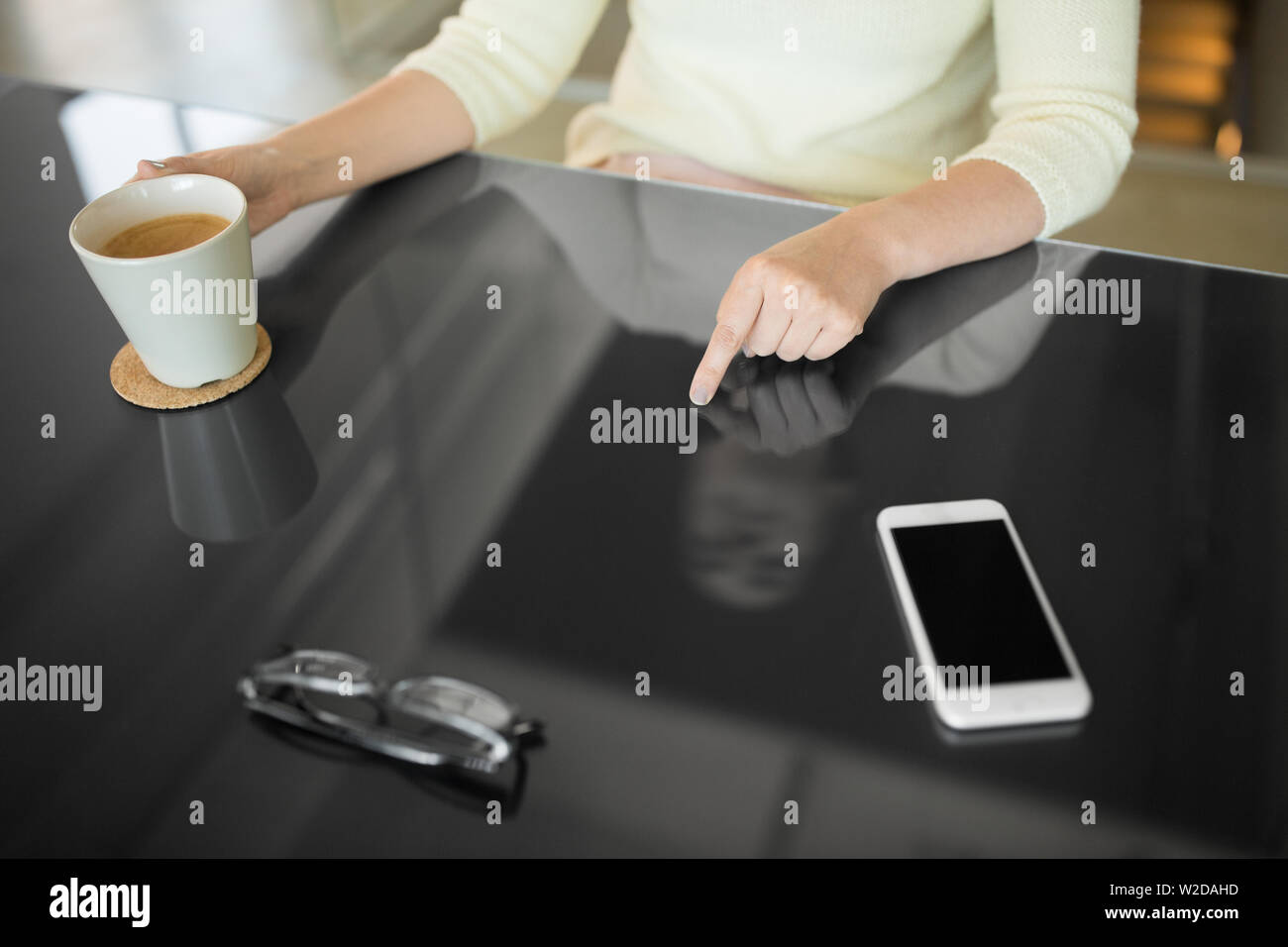 woman with coffee using black interactive panel Stock Photo