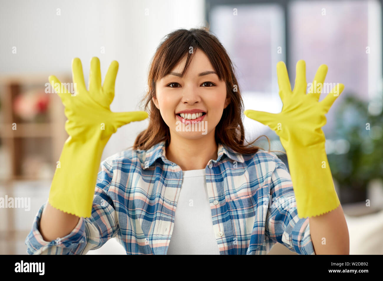 Smiling asian woman wearing rubber hires stock photography and images