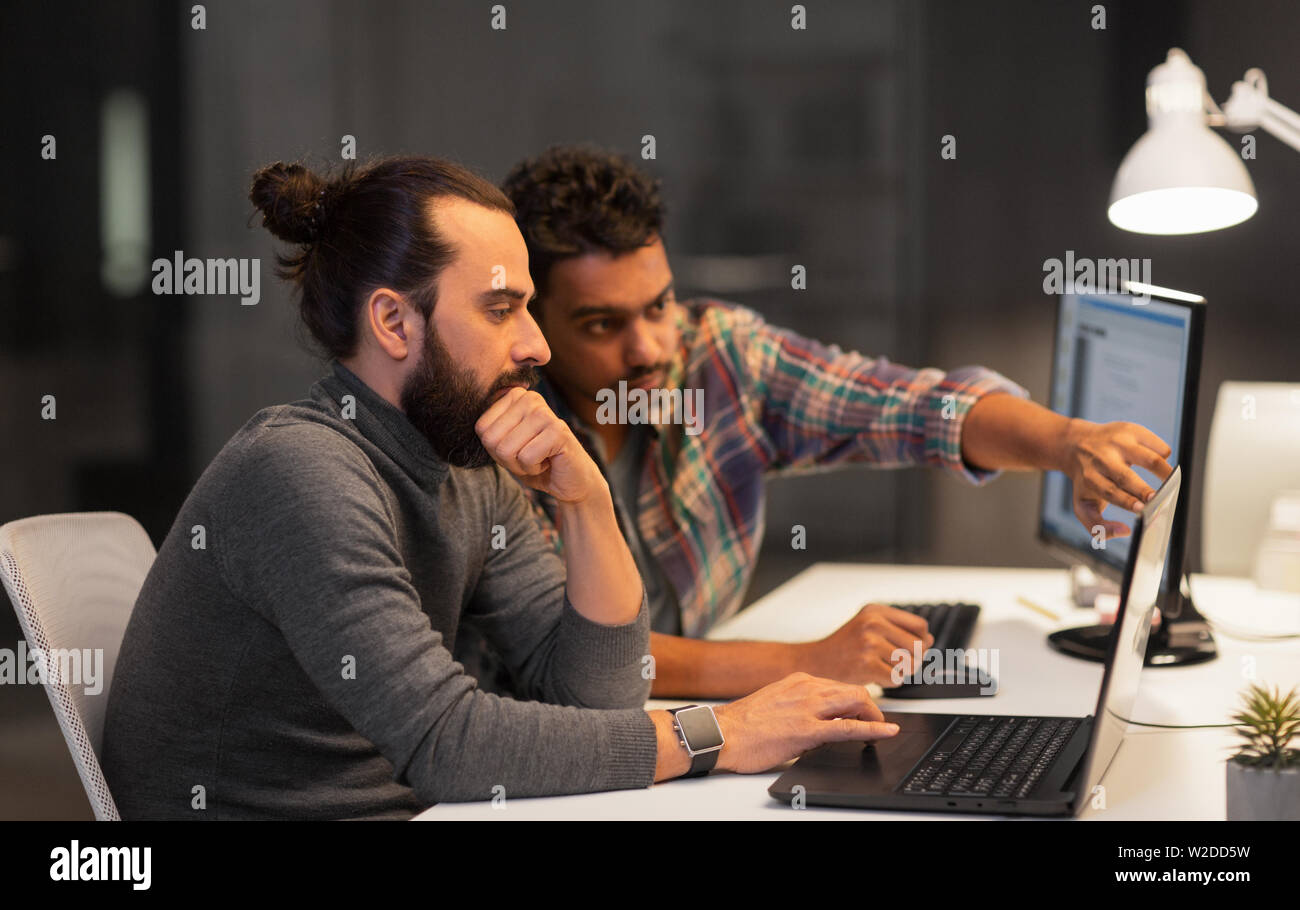 creative team with computer working late at office Stock Photo