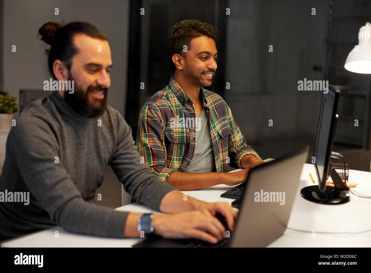 creative team with computer working late at office Stock Photo