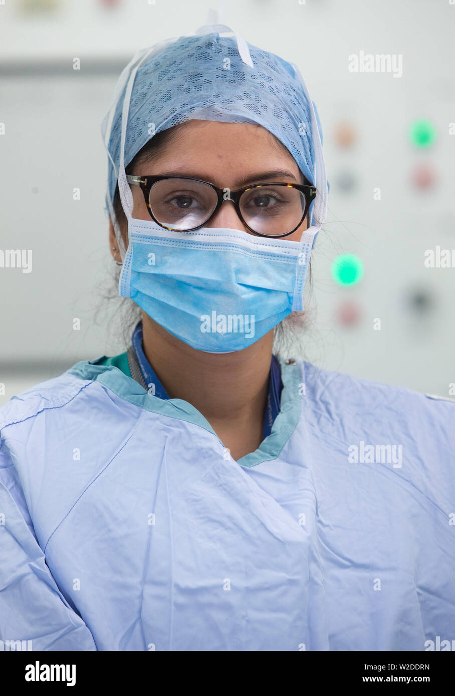 A female nurse in scrubs in an operating theatre in an NHS Hospital