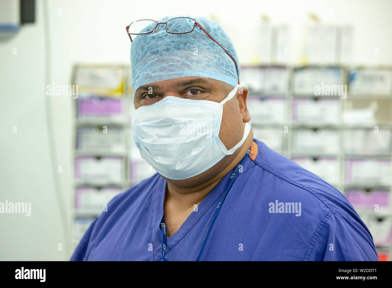 A male nurse in scrubs in an operating theatre in an NHS Hospital Stock