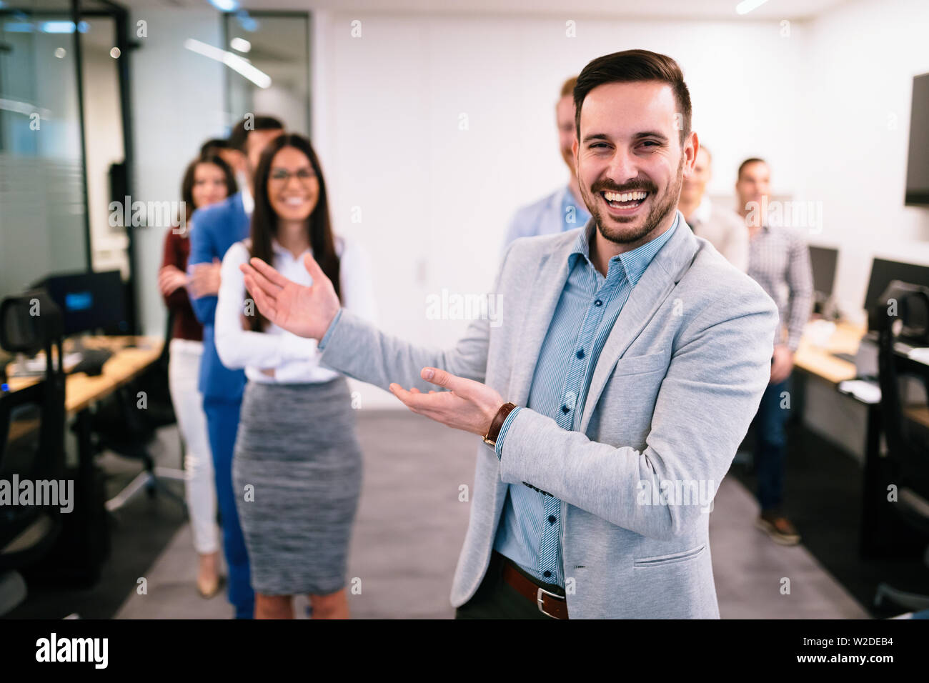 Portrait of business team posing in office Stock Photo - Alamy