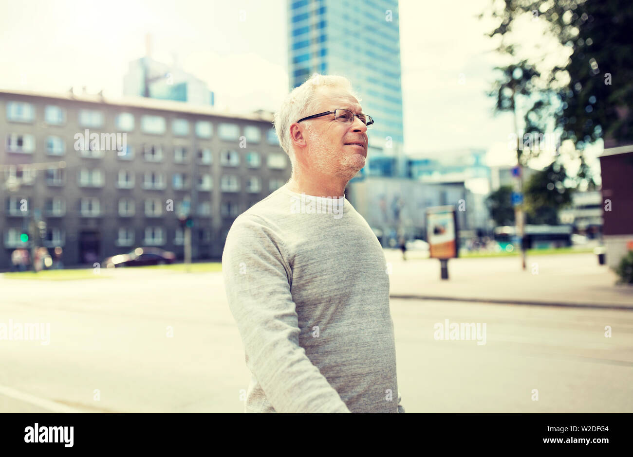 Old man walking along street hi-res stock photography and images - Alamy