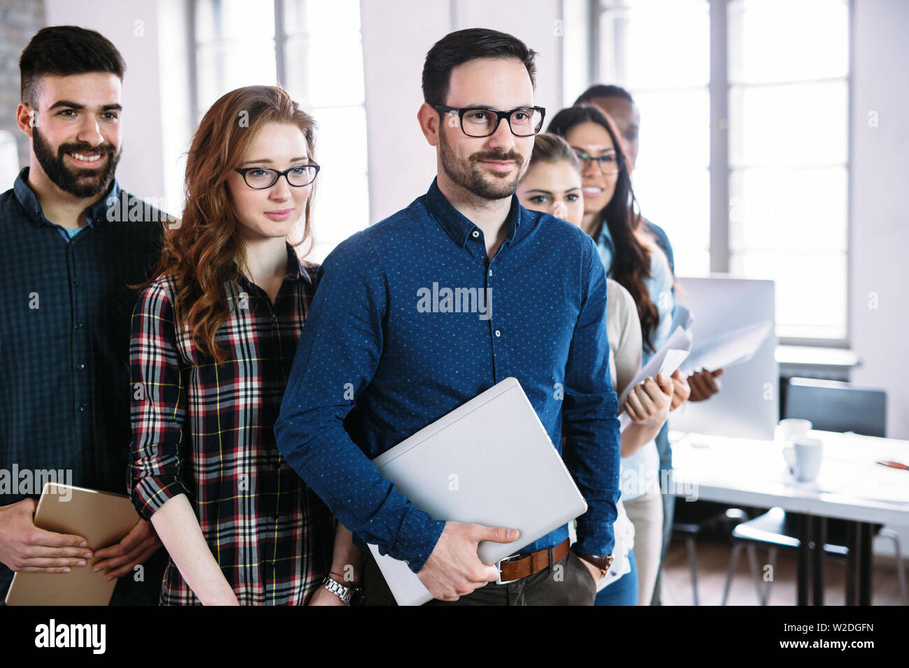 Portrait of successful business team posing in office Stock Photo - Alamy