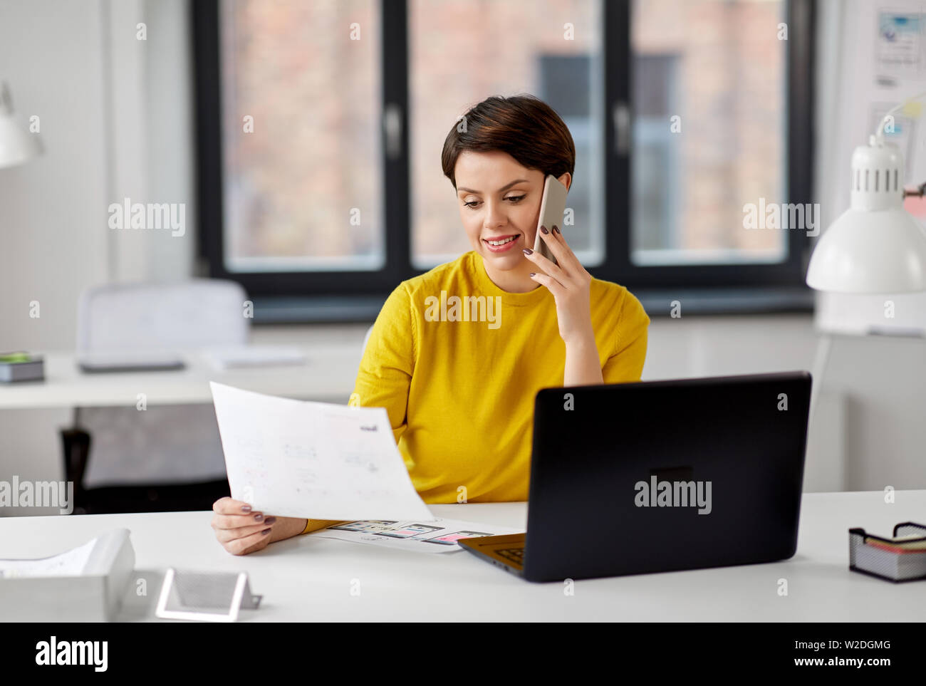 ui designer calling on smartphone at office Stock Photo