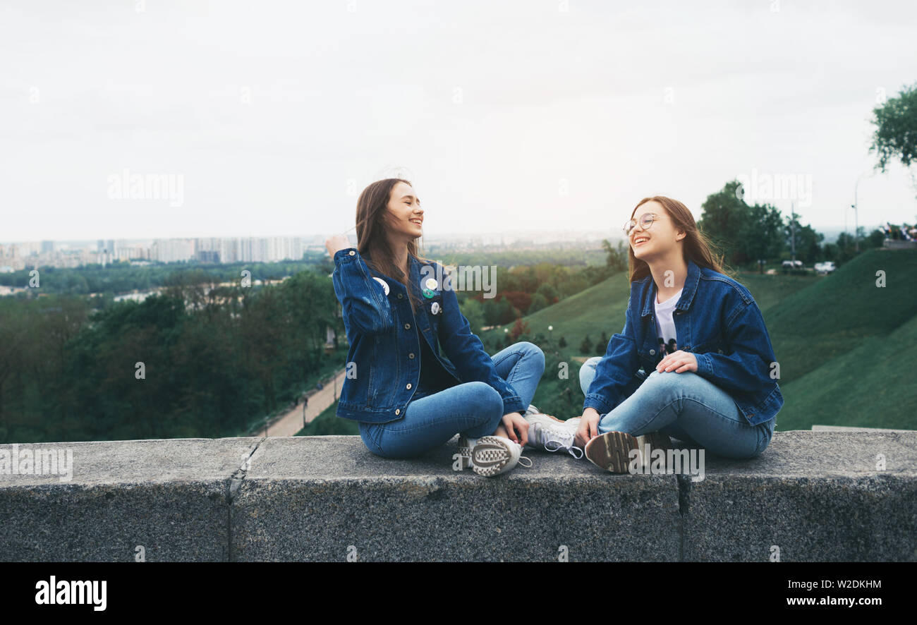 Two young happy women friends having fun in the city park Stock Photo ...