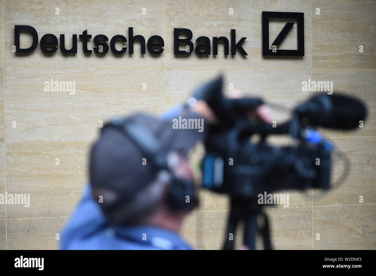 A news camerman outside the London office of Deutsche Bank which has confirmed plans to cut 18,000 positions across its global business, causing thousands of workers in the City of London to fear for their jobs. Stock Photo