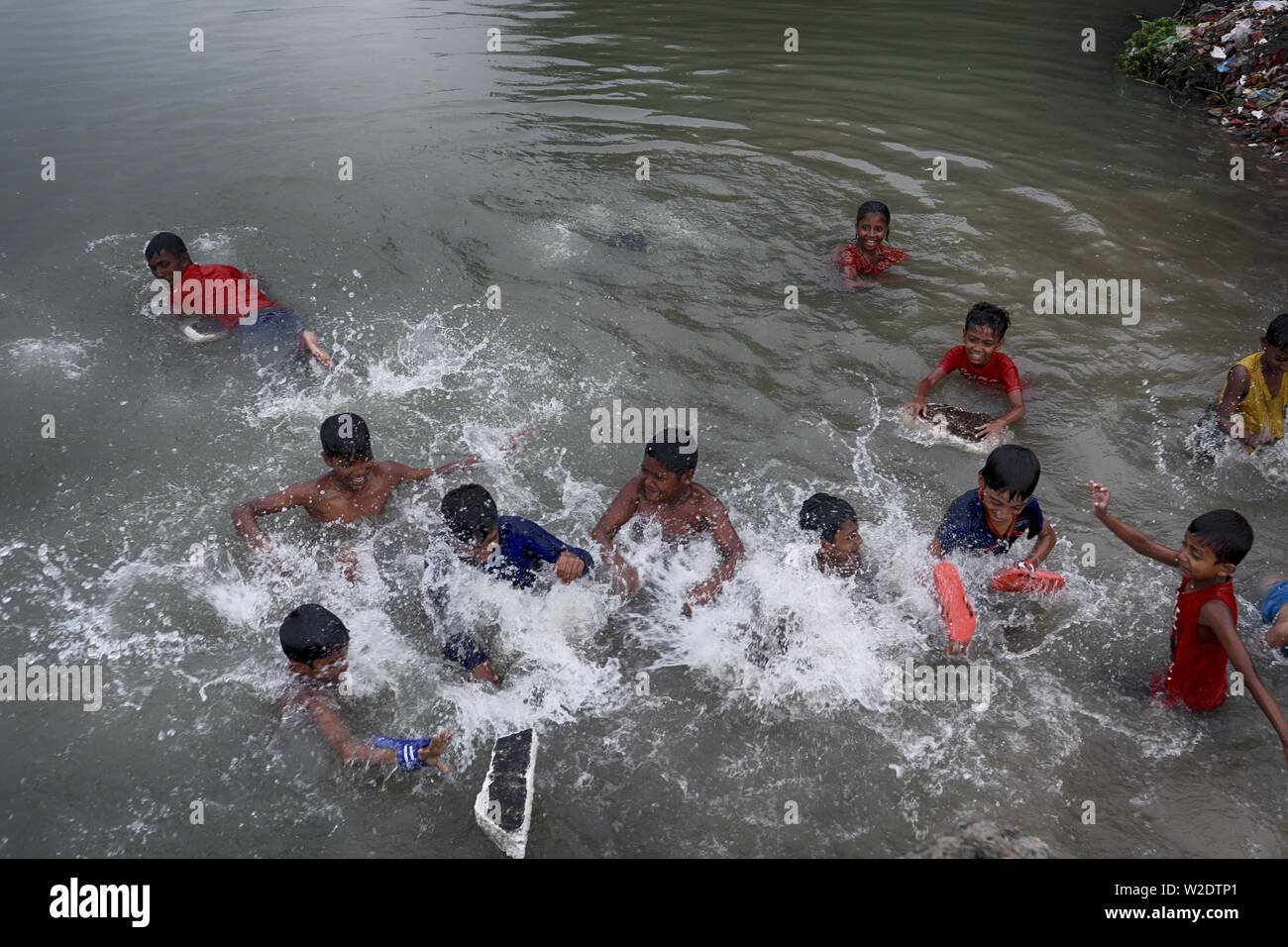 July 8, 2019 - Dhaka, Bangladesh - Children have fun while taking shower at the Buriganga River in Dhaka Bangladesh. (Credit Image: © Kazi Salahuddin via ZUMA Wire) Stock Photo