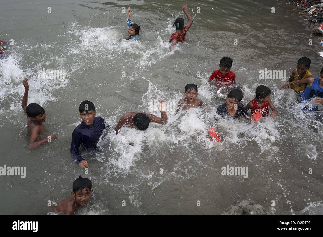July 8, 2019 - Dhaka, Bangladesh - Children have fun while taking shower at the Buriganga River in Dhaka Bangladesh. (Credit Image: © Kazi Salahuddin via ZUMA Wire) Stock Photo