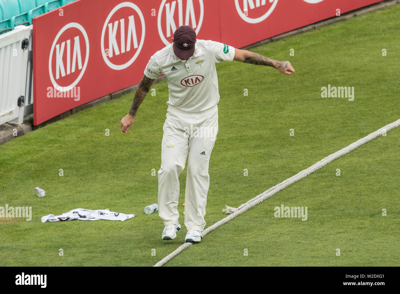 London, UK. 8th July, 2019. Jordan Clark, balancing on a rope for Surrey against Kent on day two of the Specsavers County Championship game at the Oval. Credit: David Rowe/Alamy Live News Stock Photo