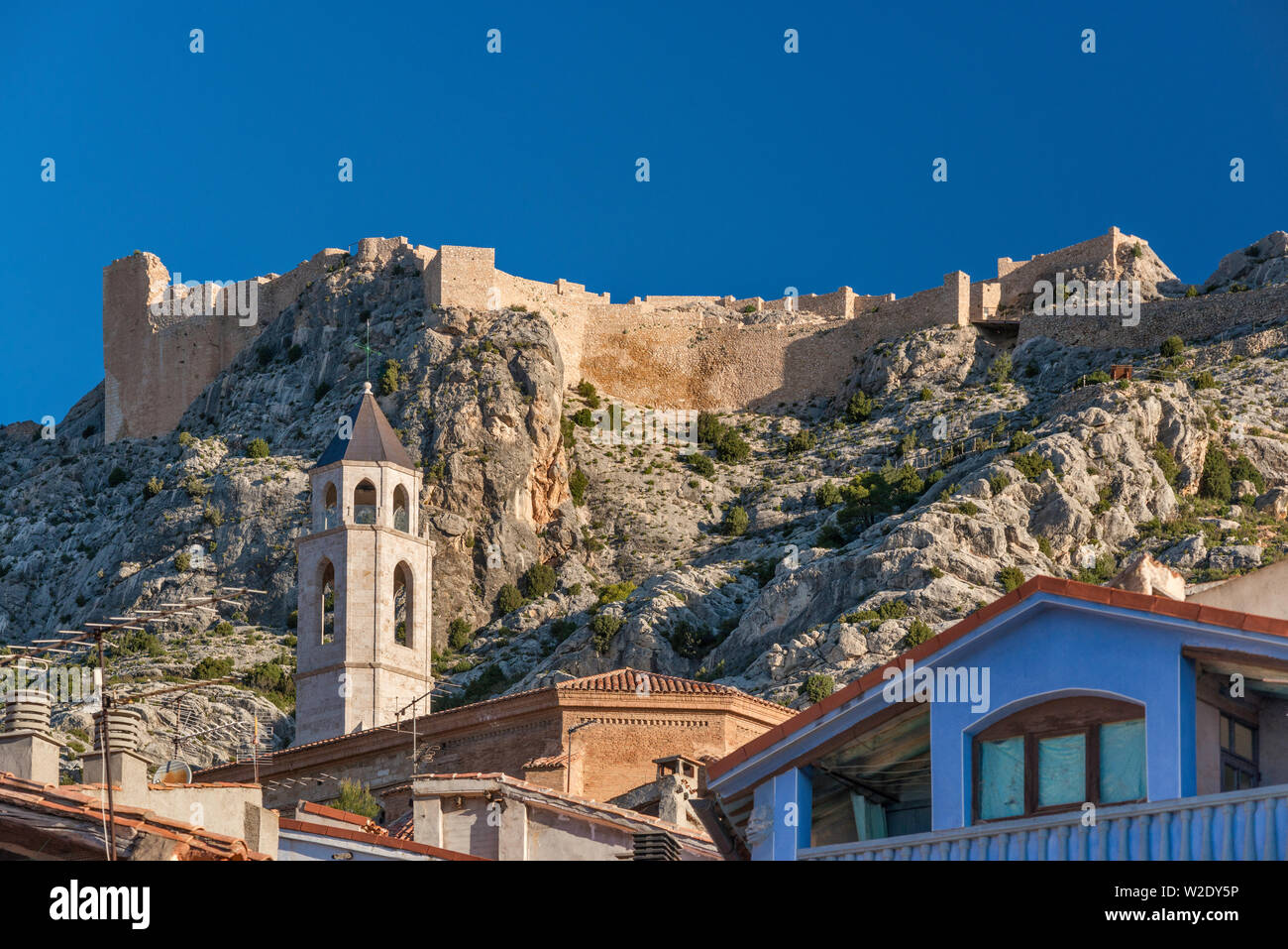 Moorish castle over Gothic church of San Miguel in town of Castellote, Maestrat (Maestrazgo) region, Teruel province, Aragon, Spain Stock Photo
