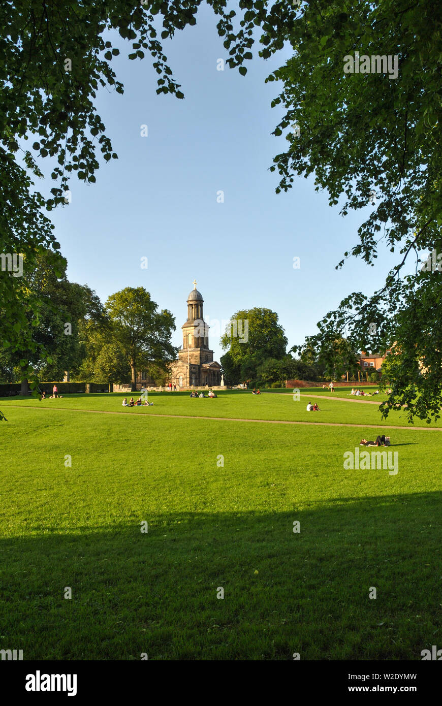 Shrewsbury Quarry Park on a summer evening showing people relaxing in the sun and St Chads Church in background Stock Photo