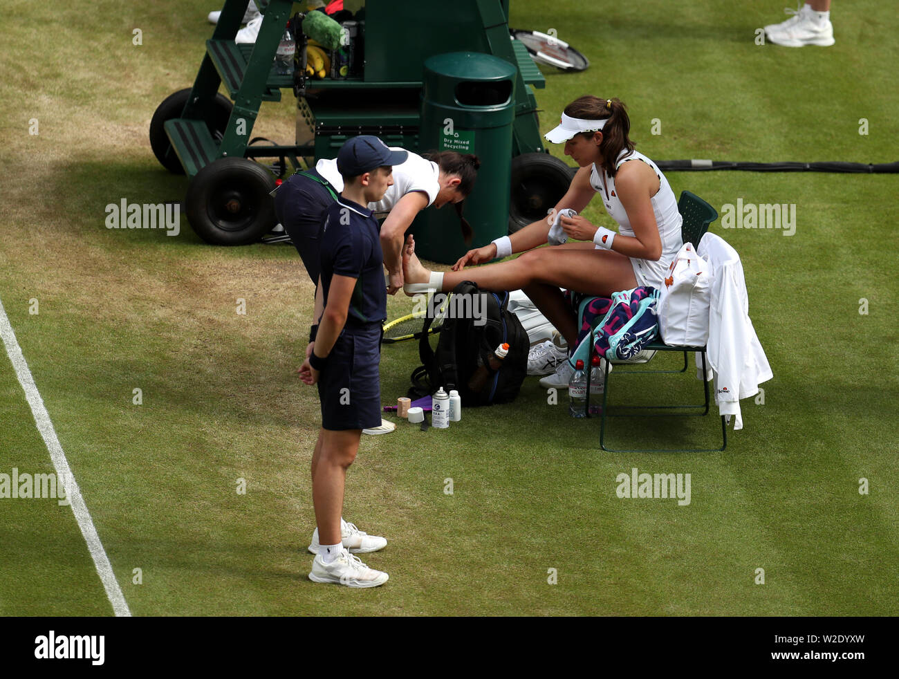 Johanna Konta receives treatment for an injury on day seven of the Wimbledon Championships at the All England Lawn Tennis and Croquet Club, Wimbledon. Stock Photo