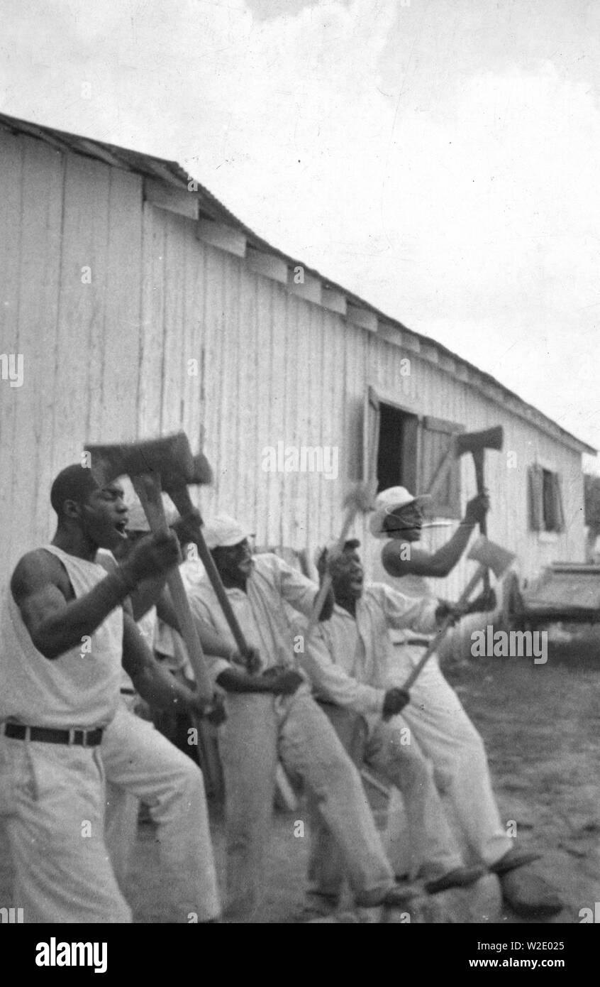 'Lightnin'' Washington, an African American prisoner, singing with his group in the woodyard at Darrington State Farm, Texas ca. April 1934 Stock Photo