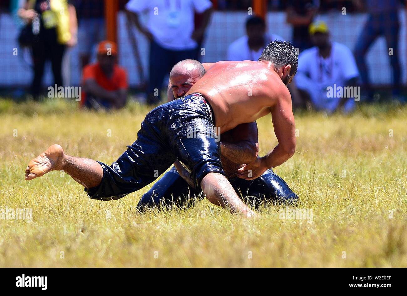 Ankara, Turkey. 7th July, 2019. Wrestlers compete during the traditional Kirkpinar Oil Wrestling Festival in Edirne, Turkey, July 7, 2019. Turkey's Kirkpinar Oil Wrestling Festival is a centuries-old traditional sport event, in which sportsmen covered with olive oil compete to win a prestigious golden belt. TO GO WITH Feature: Turkey braces for major traditional oil wrestling tournament. Credit: Ihlas News Agency/Xinhua/Alamy Live News Stock Photo