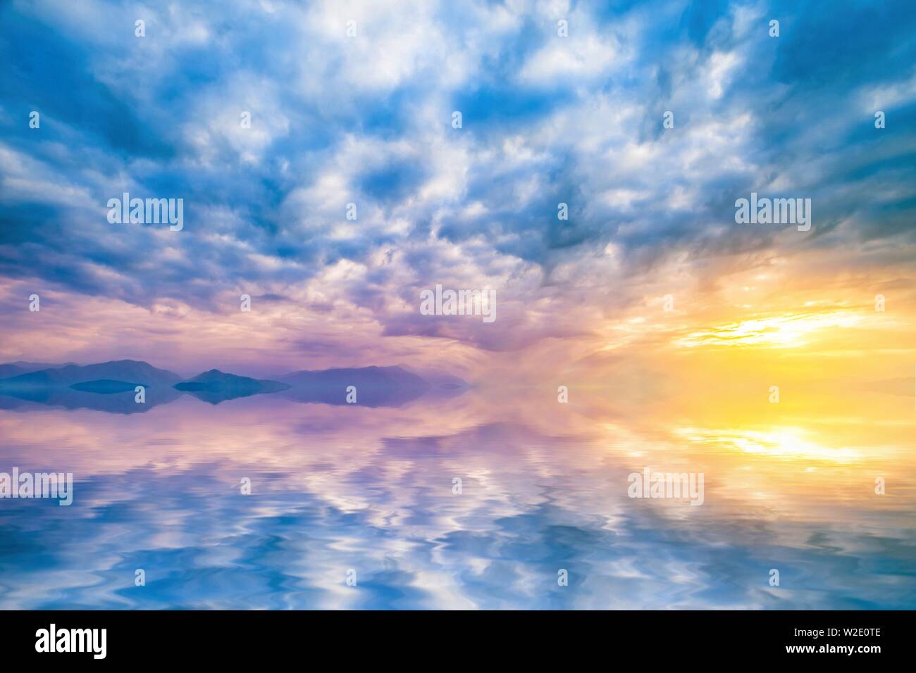 natural landscape with cloudy sky at sunset reflected in water Stock Photo