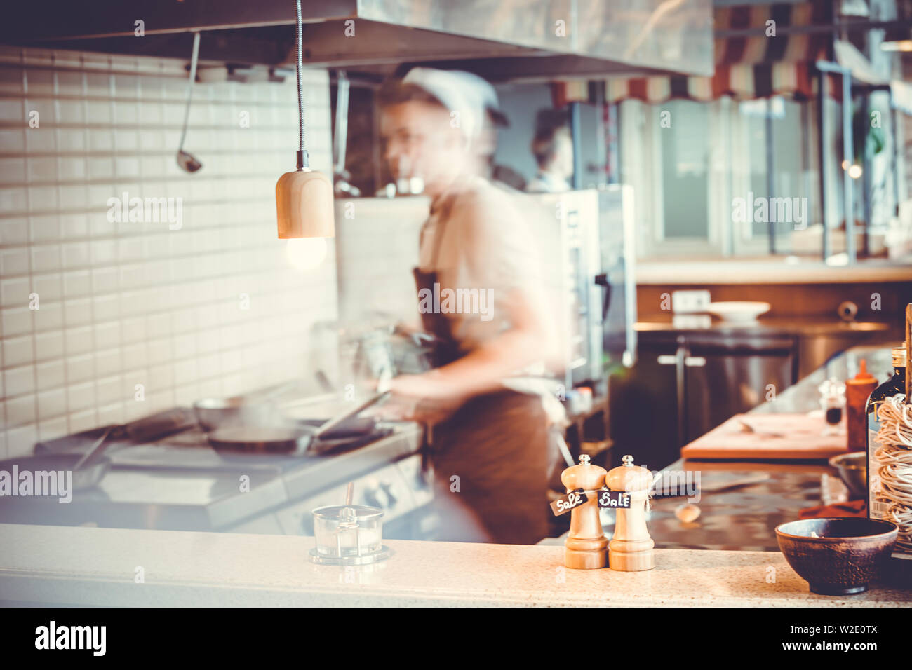 Blurred restaurant interior with salt and pepper on table Stock Photo