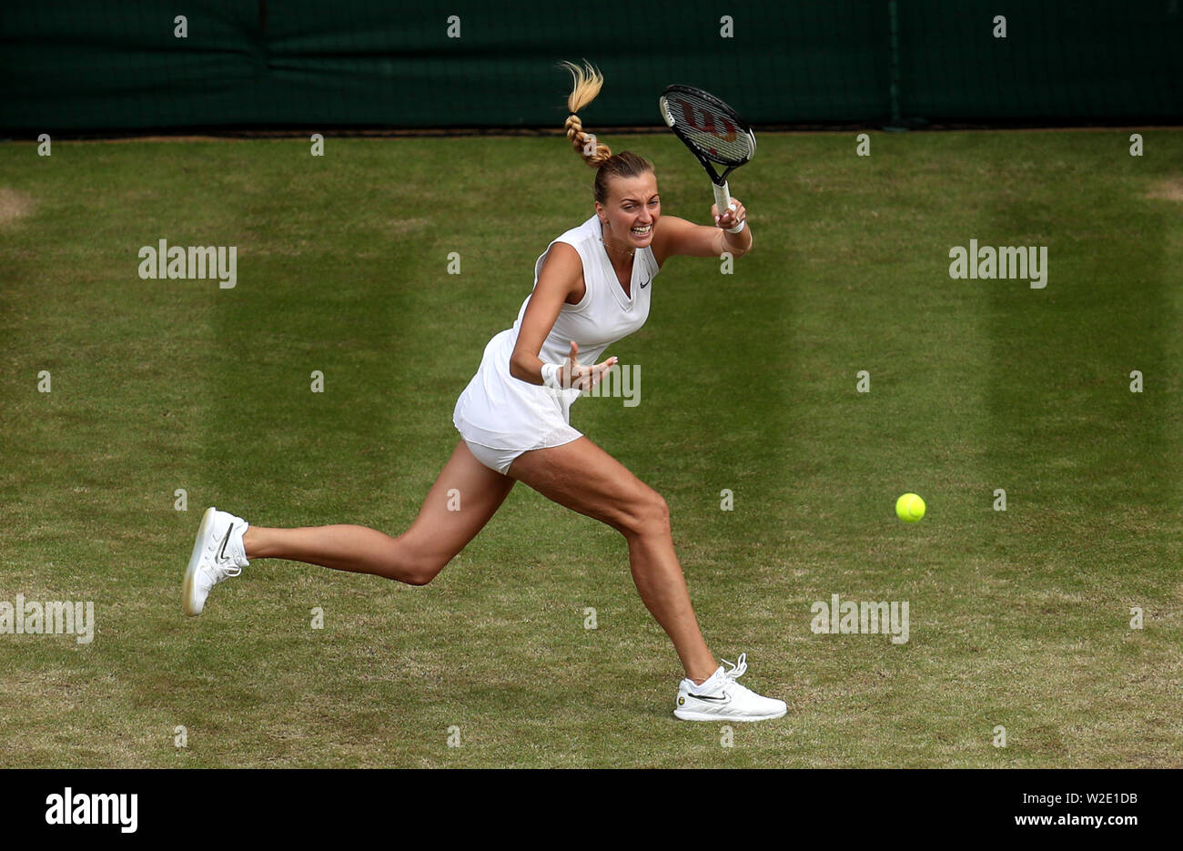 Petra Kvitova in action against Johanna Konta on day seven of the Wimbledon Championships at the All England Lawn Tennis and Croquet Club, Wimbledon. Stock Photo