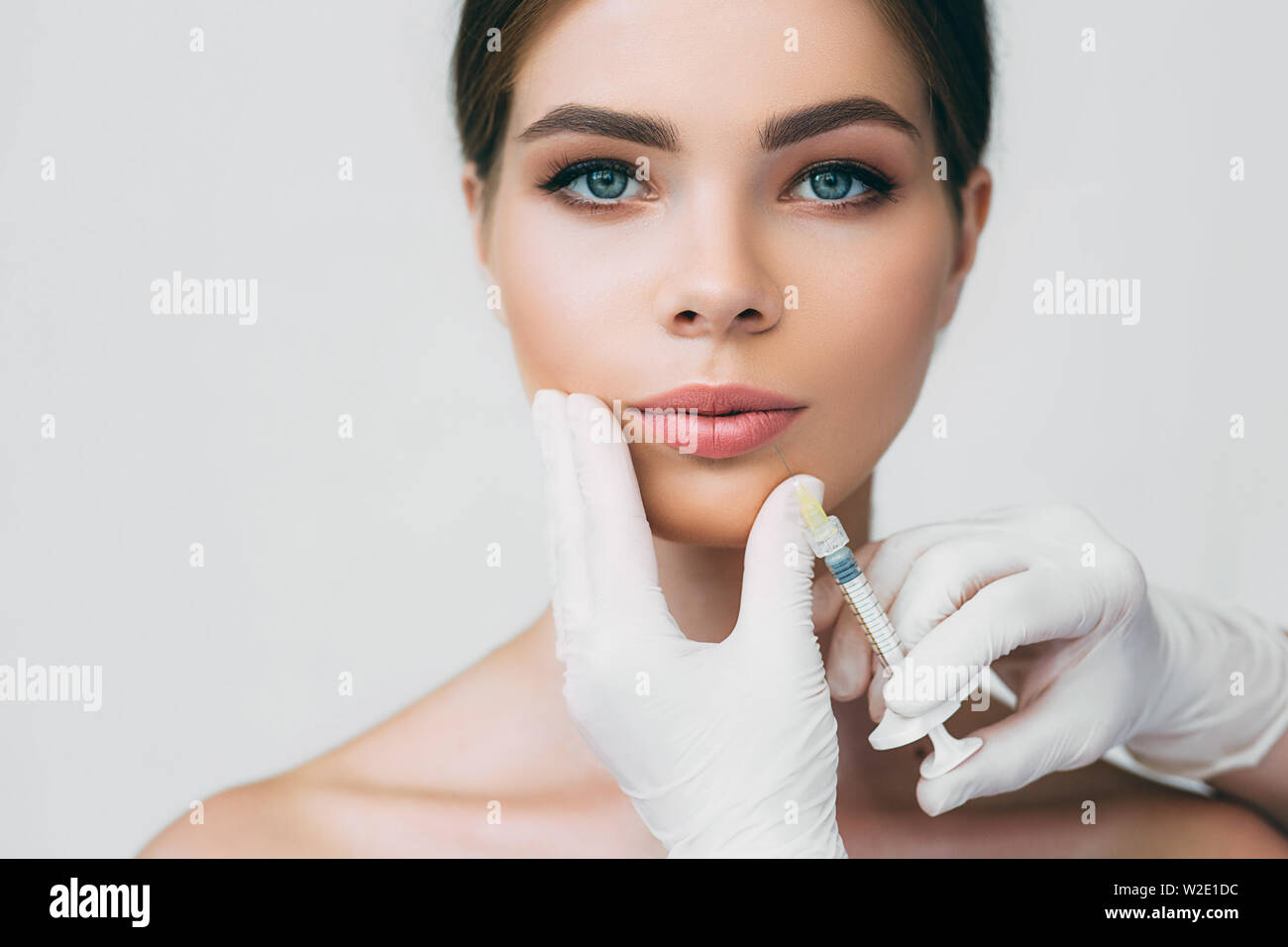 beautiful woman getting injection in her mouth for lip augmentation ...