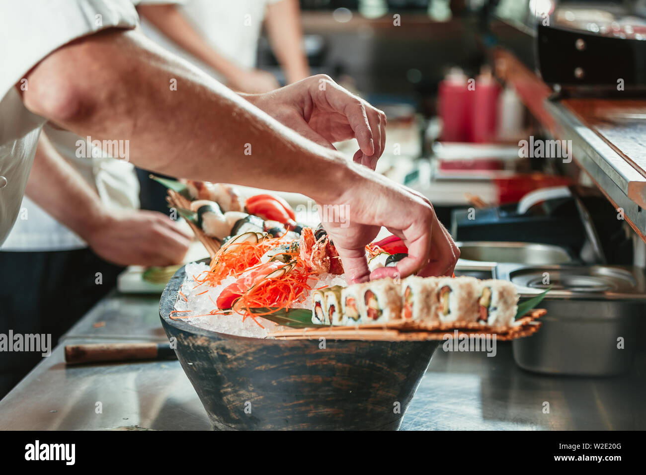 male cooks preparing sushi in the restaurant kitchen Stock Photo