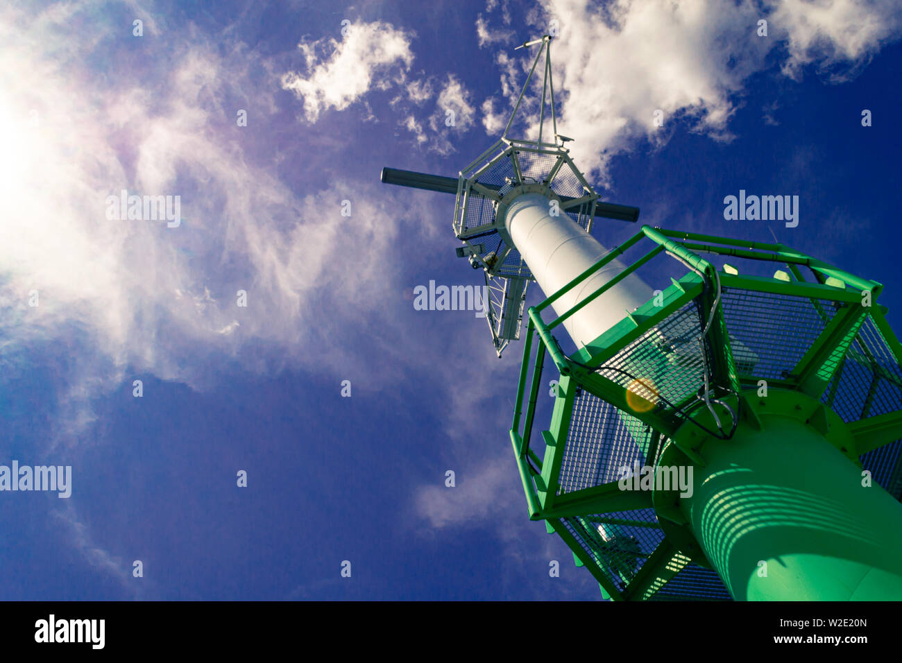 Port radar for navigation in the harbor against blue cloudy sky and sun ...