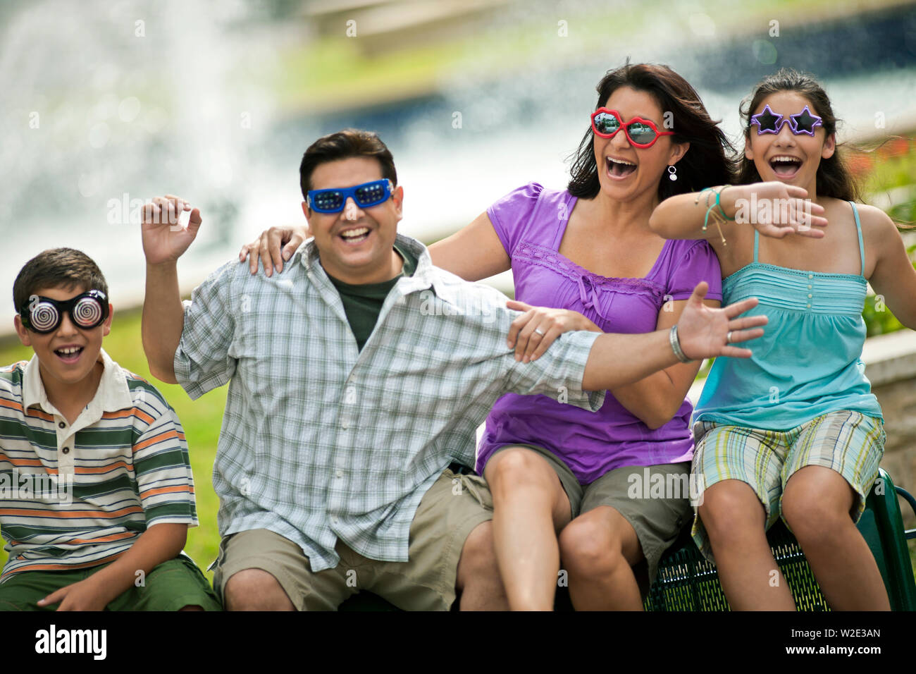 Family enjoying a day out at an amusement park Stock Photo - Alamy